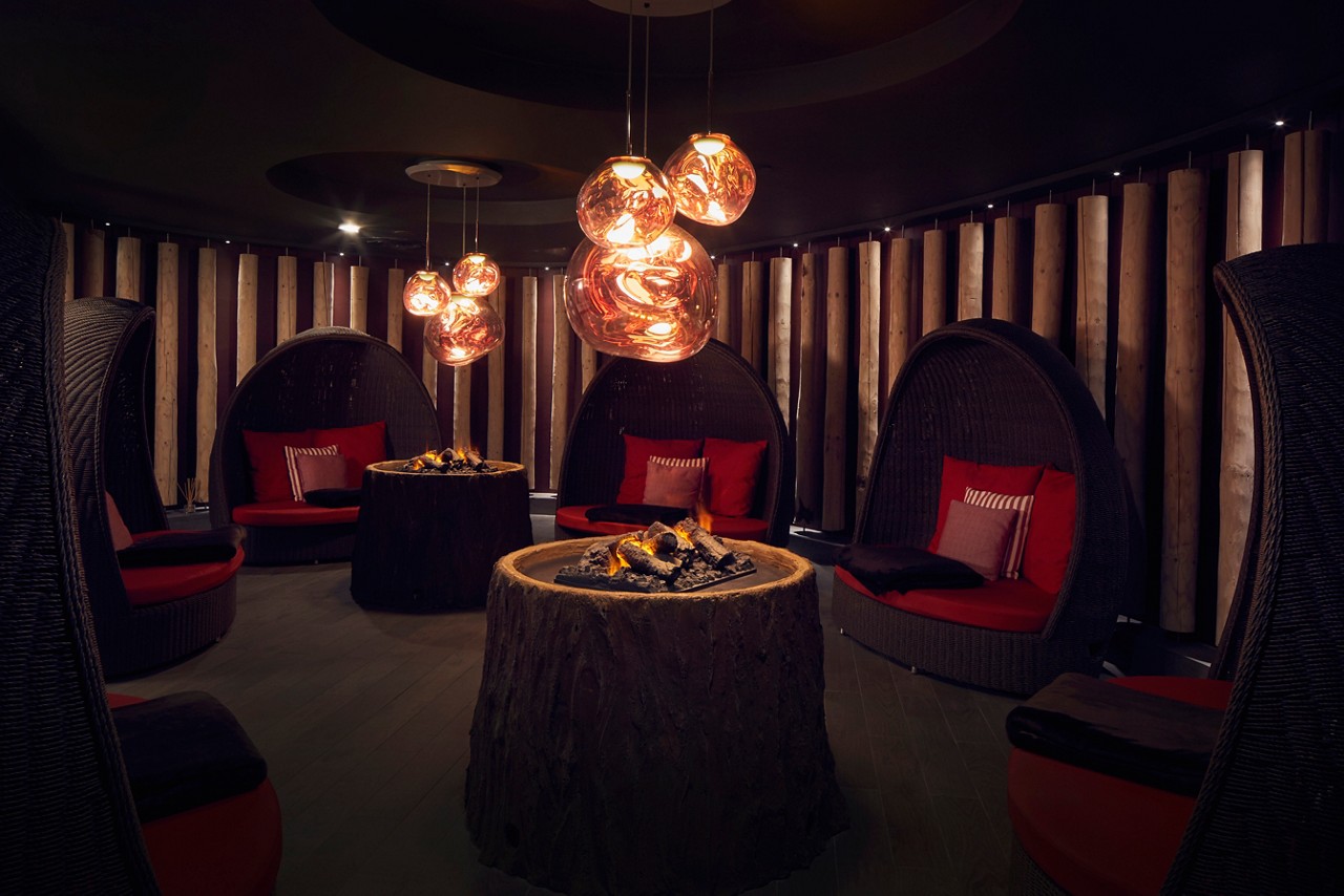 Fireside Relax room with glowing fires and large cocoon seating.